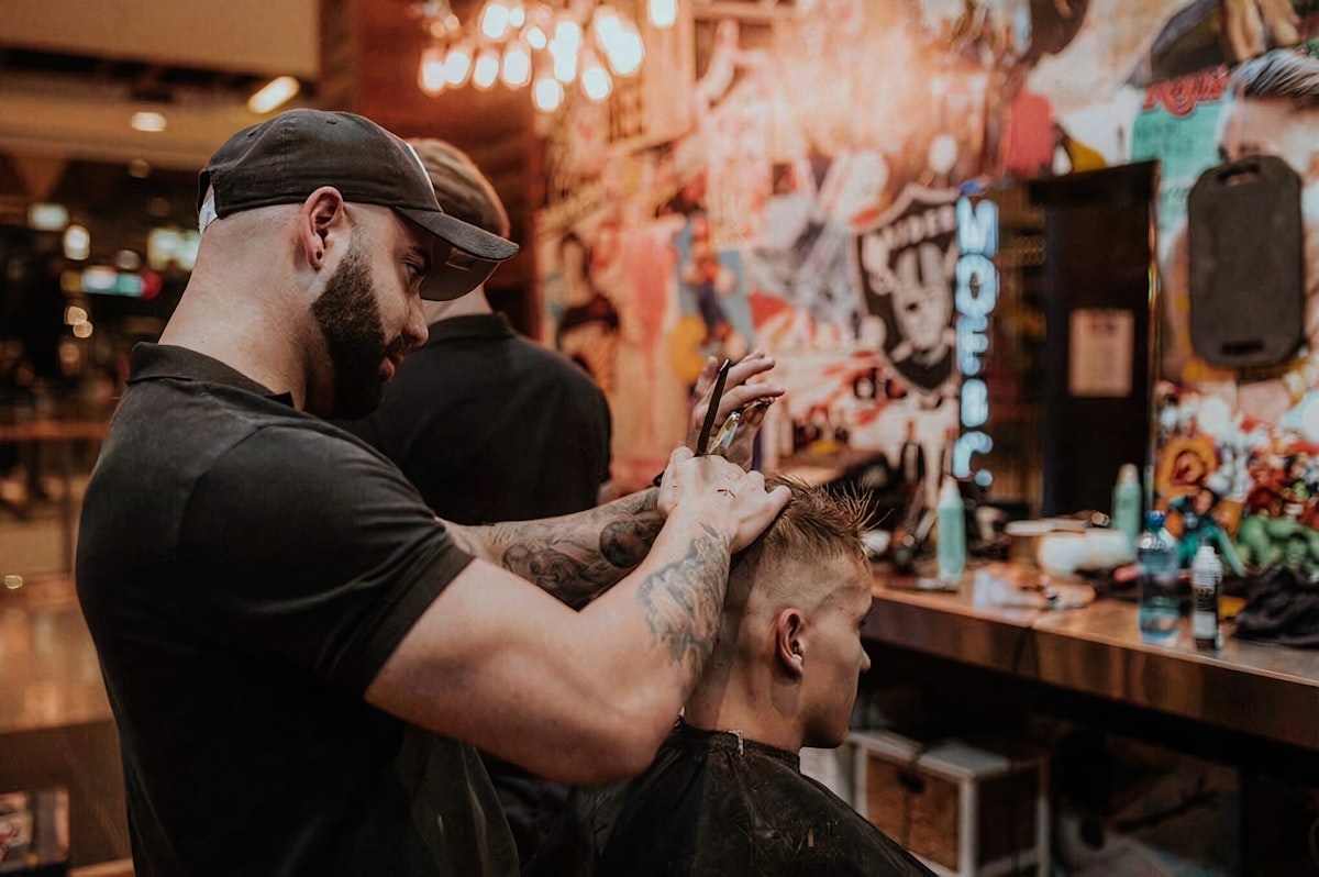 Barber styling a men's haircut